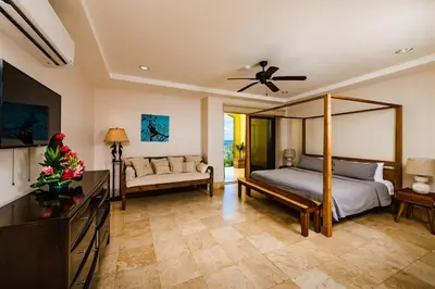 a bedroom with a bed and a couch at Beachfront Oceanview Private Jacuzzi & Full ktcn in Tamarindo