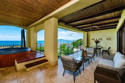 a living room with a balcony with a hot tub at Beachfront Oceanview Private Jacuzzi & Full ktcn in Tamarindo