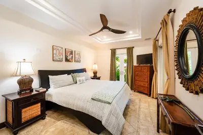 a bedroom with a bed and a mirror and a dresser at Beachfront Easy Beach access, security & cameras in Tamarindo
