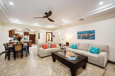 a living room with a couch and a table at Beachfront Easy Beach access, security & cameras in Tamarindo