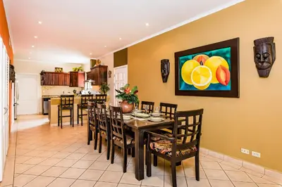 a kitchen and dining room with a table and chairs at Amazing Condo Across the Street from the Beach in Tamarindo