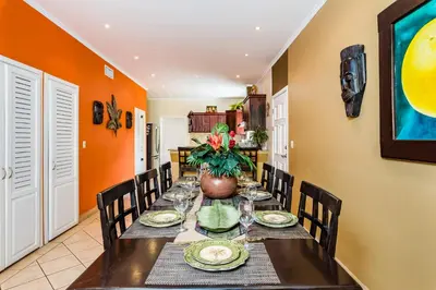 a dining room with a long table and chairs at Amazing Condo Across the Street from the Beach in Tamarindo