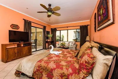 a bedroom with a large bed with a swan on it at Amazing Condo Across the Street from the Beach in Tamarindo