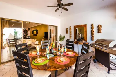 a dining room with a wooden table and chairs at Amazing Condo Across the Street from the Beach in Tamarindo