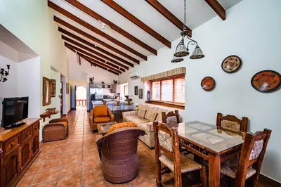 a living room with a table and a couch at Beachfront Ocean view terrace right on the beach in Tamarindo