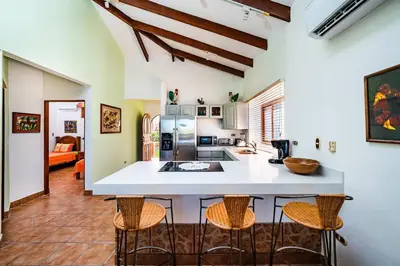 a kitchen with a large island in a room at Beachfront Ocean view terrace right on the beach in Tamarindo
