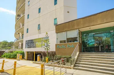 a building with a parking lot in front of it at Pura vida charm, canopy views, block from beach in Tamarindo