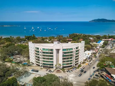 an aerial view of a building with the ocean in the background at Pura vida charm, canopy views, block from beach in Tamarindo