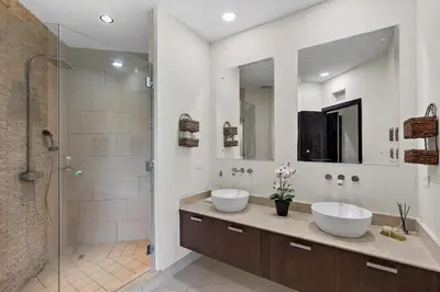 a bathroom with two sinks and a shower at Pura vida charm, canopy views, block from beach in Tamarindo