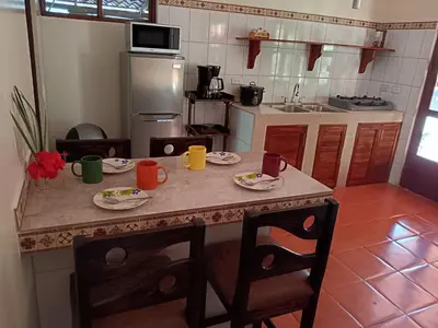 a kitchen with a table with plates of food on it at Casa Amapola in La Cruz