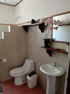 a bathroom with a toilet and a sink at Casa Amapola in La Cruz