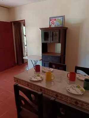 a dining room table with plates and mugs on it at Casa Amapola in La Cruz