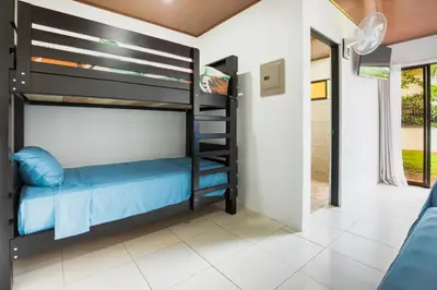 a bedroom with bunk beds in a house at Rio Celeste Birds Garden Apartment con Aire Acondicionado Comodidad en un Entorno Natural 1 in Upala