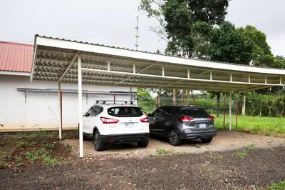two cars parked under a parking lot at Rio Celeste Birds Garden Apartment con Aire Acondicionado Comodidad en un Entorno Natural 1 in Upala