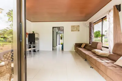a living room with a couch and a window at Rio Celeste Birds Garden Apartment con Aire Acondicionado Comodidad en un Entorno Natural 1 in Upala