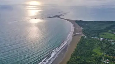 an aerial view of a beach and the ocean at Cabañas MOHES ballena in Uvita