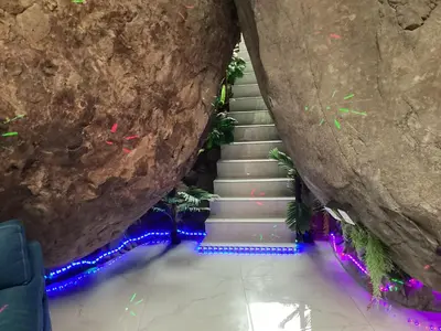 a staircase leading up to a cave with christmas lights at Rocka Verde Retreat 8th Wonder of the World in Rivas