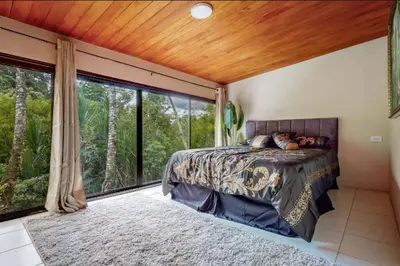a bedroom with a bed and a large window at Rocka Verde Retreat 8th Wonder of the World in Rivas