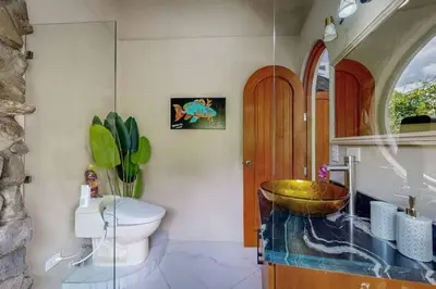 a bathroom with a bowl sink and a toilet at Rocka Verde Retreat 8th Wonder of the World in Rivas
