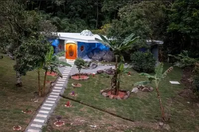 a small house in a yard with trees at Rocka Verde Retreat 8th Wonder of the World in Rivas