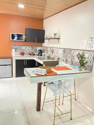 a kitchen with a counter and a table with chairs at Apartamentos H Gonzalez. Wifi A/C free parking in San Rafael