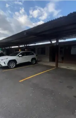 a white car parked in a parking lot at Apartamentos H Gonzalez. Wifi A/C free parking in San Rafael