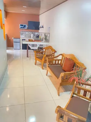 a living room with wooden chairs and a kitchen at Apartamentos H Gonzalez. Wifi A/C free parking in San Rafael