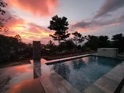 a swimming pool with a sunset in the background at Casa Alexa Venecia in Venecia
