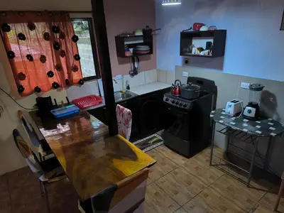 a small kitchen with a table and a stove at La Martha in Sarapiquí