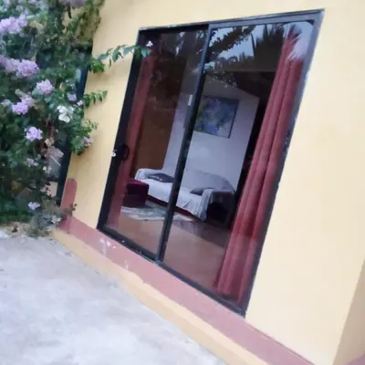 a reflection of a bedroom in a mirror at La Martha in Sarapiquí