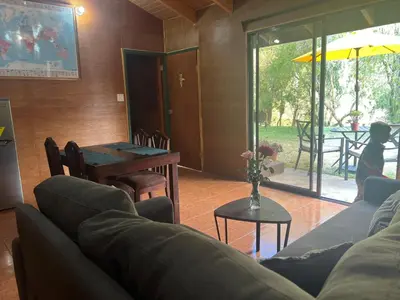 a living room with a couch and a table at Casa D'Pa in San Gerardo de Dota