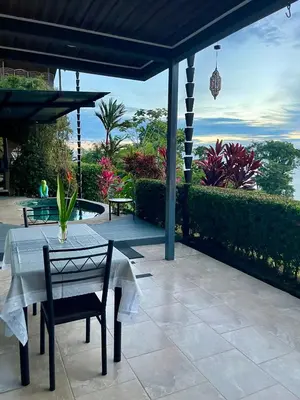 a table and chairs on a patio with a view at Villa Del Mar 1 Spectacular ocean view! in Dominical