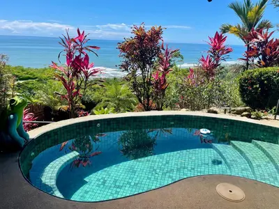 a swimming pool with a view of the ocean at Villa Del Mar 1 Spectacular ocean view! in Dominical