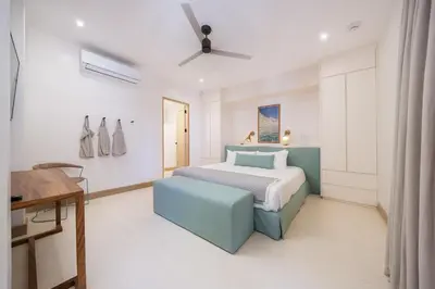 a white bedroom with a bed and a desk at Beach, Oceanfront 2BR, 2BA Condo in Las Catalinas - Plaza Mercado 12 in Playa Danta
