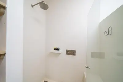 a white shower with a light on a wall at Beach, Oceanfront 2BR, 2BA Condo in Las Catalinas - Plaza Mercado 12 in Playa Danta