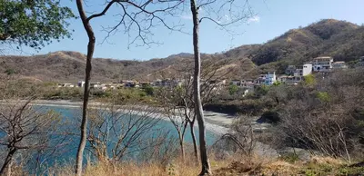 a view of a river with houses on a mountain at Beach, Oceanfront 2BR, 2BA Condo in Las Catalinas - Plaza Mercado 12 in Playa Danta