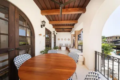 an indoor balcony with a wooden table and chairs at Beach, Oceanfront 2BR, 2BA Condo in Las Catalinas - Plaza Mercado 12 in Playa Danta