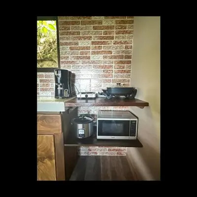 a kitchen with a counter top with a microwave at Casa Típica La Cruz in Monteverde Costa Rica