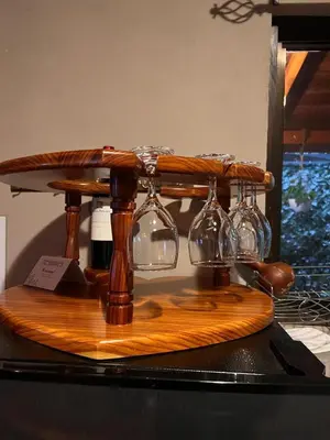 a wooden table with wine glasses on top of it at Casa Típica La Cruz in Monteverde Costa Rica