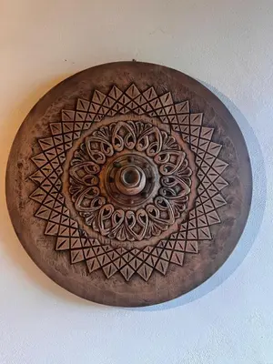 a wooden plate with a circular design on a ceiling at Casa Típica La Cruz in Monteverde Costa Rica