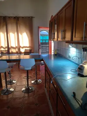 a kitchen with blue counter tops and bar stools at casa-patriana in San Ramón