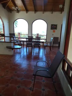 a room with a table and chairs in a building at casa-patriana in San Ramón