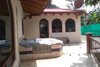 a bed in the back of a house at casa-patriana in San Ramón