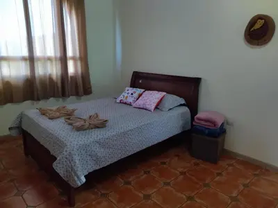 a bedroom with a bed with two pillows on it at casa-patriana in San Ramón