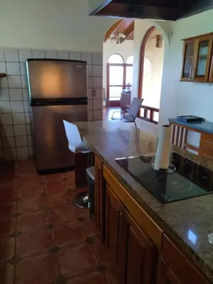 a kitchen with a refrigerator and a counter top at casa-patriana in San Ramón