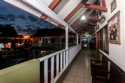 a balcony of a restaurant with a view of the city at Cadillac Rock Beach Hotel in Jacó