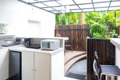 a kitchen with a microwave on a patio at La Vela Boutique Hotel in Manuel Antonio