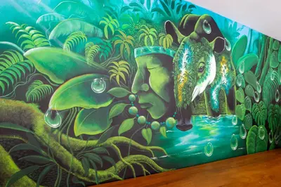 a wall with a painting of a fish on it at La Vela Boutique Hotel in Manuel Antonio