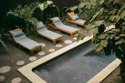 a group of chairs sitting next to a swimming pool at Mar Botánico - Avellanas Beach Hotel in Playa Avellana