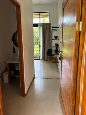 a hallway with a door open to a room at Mar Botánico - Avellanas Beach Hotel in Playa Avellana